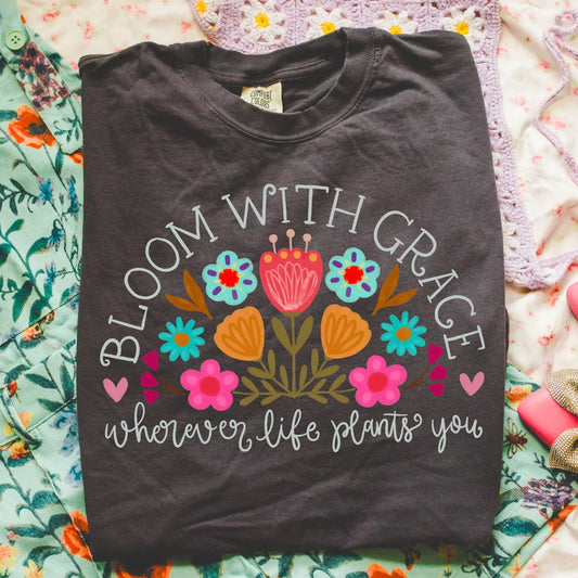 White Bloom With Grace Wherever Life Plants You Black Tee